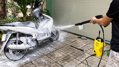 Phun dung dịch rửa xe bằng máy rửa xe